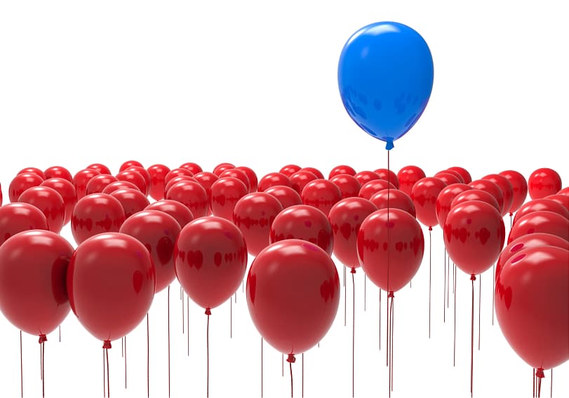 Ballon gonflable bleu qui sort d'autres ballons tous rouge : c'est l'inclusion